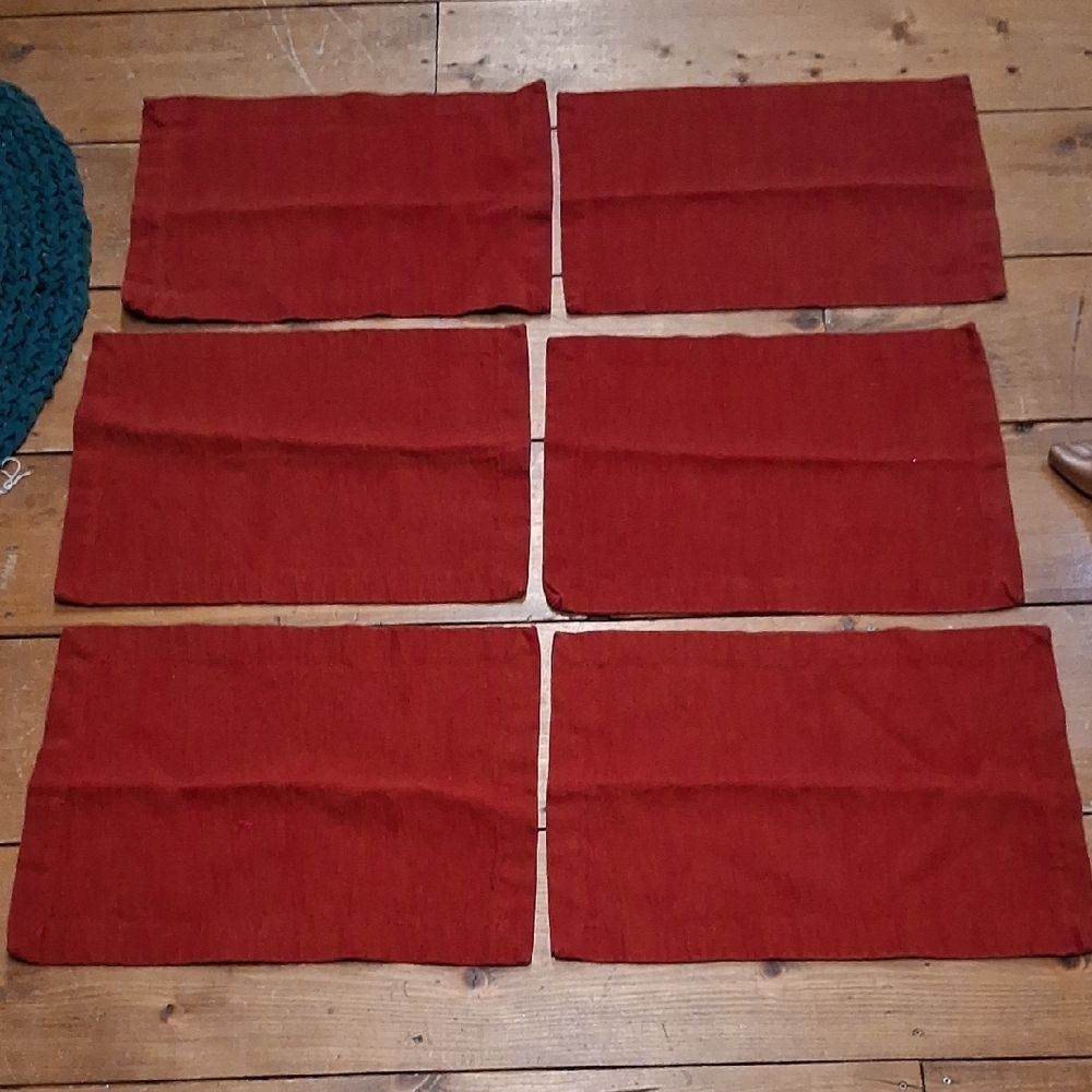Set of 7‎ red corduroy placemats.